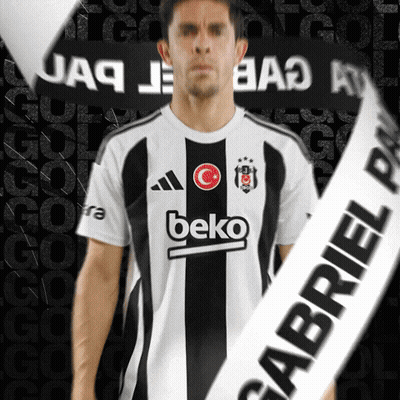 A Man Wearing A Beko Shirt Stands In Front Of A Black Background GIF