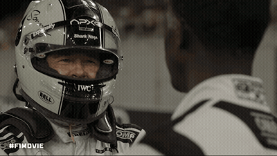 A Man Wearing A Bell Helmet Looks At Another Man GIF