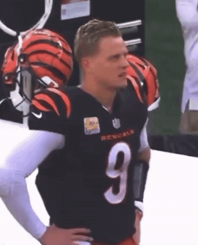 A Man Wearing A Bengals Jersey With The Number 9 GIF