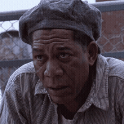 A Man Wearing A Beret And A Striped Shirt Looks At The Camera GIF