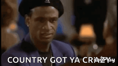 A Man Wearing A Beret And A Suit Is Making A Funny Face And Saying `` Country Got Ya Crazy . '' GIF