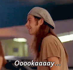 A Man Wearing A Beret Is Smiling And Saying Ooookaaay ... GIF