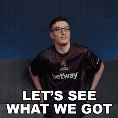 A Man Wearing A Betway Shirt Is Sitting On A Couch And Says Let 'S See What We Got . GIF