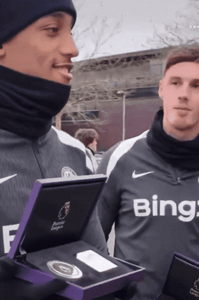 A Man Wearing A Bing Shirt Holds A Box GIF