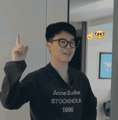 A Man Wearing A Black Acne Studios Stockholm 1996 Sweatshirt Points Up GIF