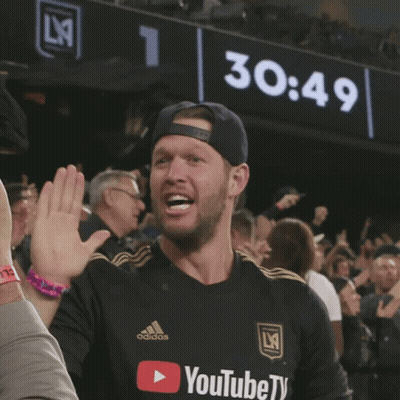 A Man Wearing A Black Adidas Shirt Giving A High Five GIF