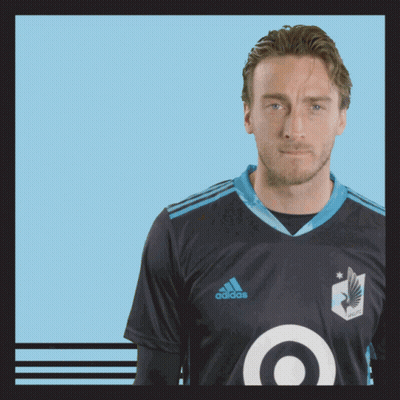 A Man Wearing A Black Adidas Shirt With A Blue Target On The Front GIF