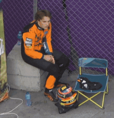 A Man Wearing A Black And Orange Jacket That Says Mastercard GIF