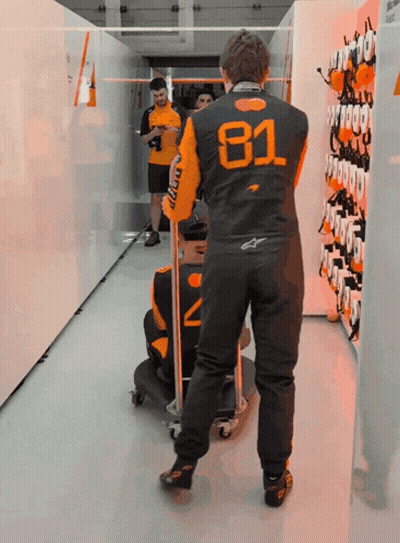 A Man Wearing A Black And Orange Jacket With The Number 81 On It GIF