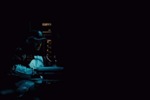 A Man Wearing A Black And White Jacket With The Word Ok On The Front GIF