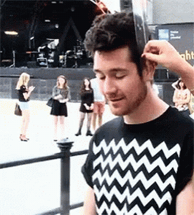 A Man Wearing A Black And White Shirt With A Zig Zag Pattern GIF