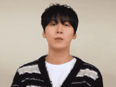 A Man Wearing A Black And White Striped Sweater Looks At The Camera GIF