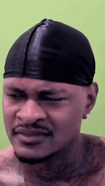 A Man Wearing A Black Beanie Has A Tattoo On His Chest GIF