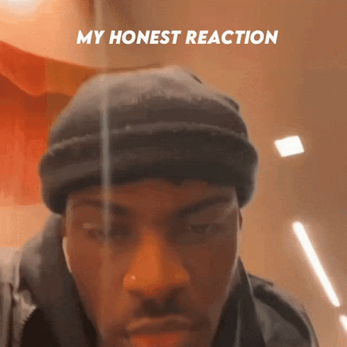 A Man Wearing A Black Beanie Has The Words My Honest Reaction Above His Face GIF