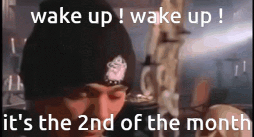 A Man Wearing A Black Beanie Says Wake Up ! Wake Up ! It 'S The 2Nd Of The Month . GIF