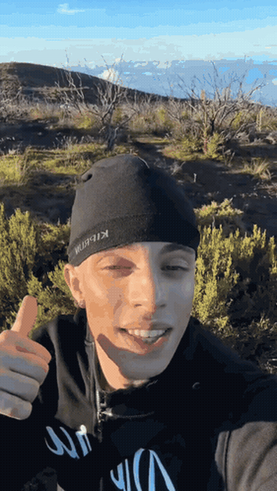 A Man Wearing A Black Beanie With The Word Kibbit On It GIF