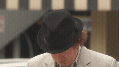A Man Wearing A Black Fedora And A White Jacket GIF