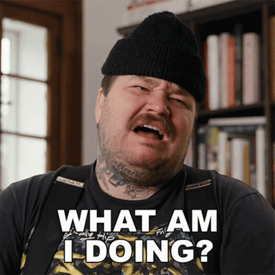 A Man Wearing A Black Hat And A Black Shirt Says What Am I Doing GIF