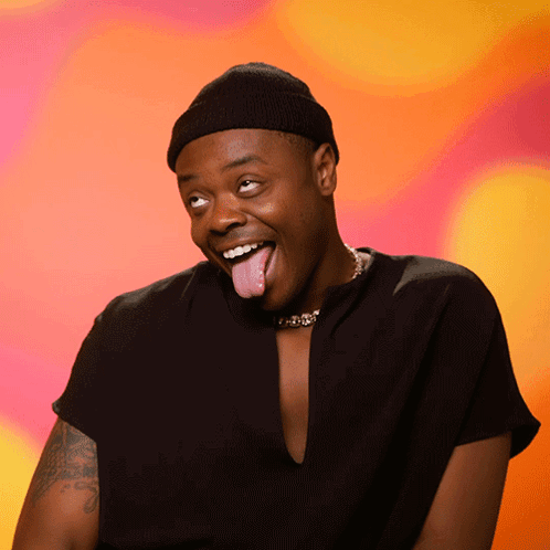 A Man Wearing A Black Hat And A Black Shirt Sticking His Tongue Out GIF