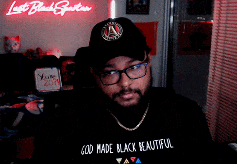 A Man Wearing A Black Hat And A Black Shirt That Says God Made Black Beautiful GIF