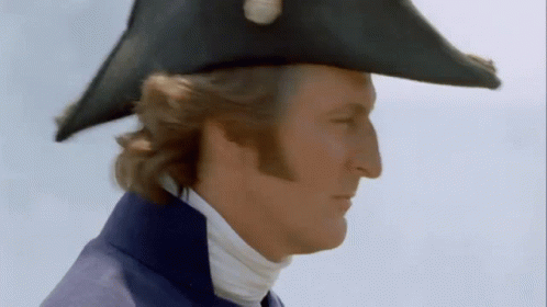 A Man Wearing A Black Hat And A Blue Coat GIF
