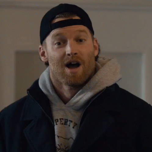A Man Wearing A Black Hat And A Grey Sweatshirt That Says Property GIF