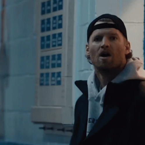 A Man Wearing A Black Hat And A Hoodie That Says Er GIF