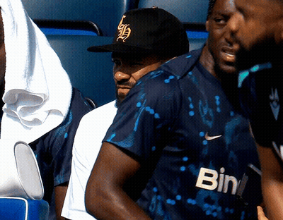 A Man Wearing A Black Hat And A Shirt That Says Bin GIF