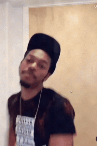 A Man Wearing A Black Hat And A T-Shirt That Says ' I 'M A Freak ' On It GIF