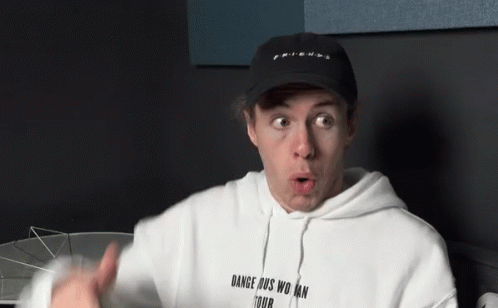 A Man Wearing A Black Hat And A White Hoodie That Says Dangerous Woman Tour GIF