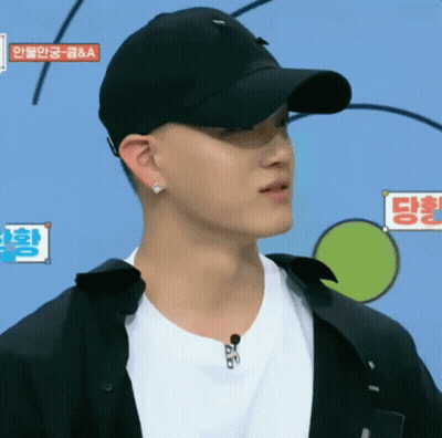 A Man Wearing A Black Hat And A White Shirt Has A Sign Above His Head That Says ' A & A ' GIF