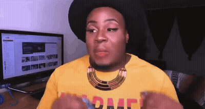 A Man Wearing A Black Hat And A Yellow Shirt With The Word Peace On The Front GIF