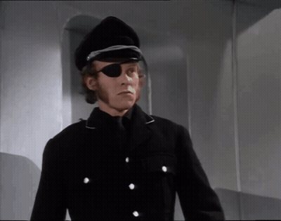 A Man Wearing A Black Hat And Eye Patch GIF