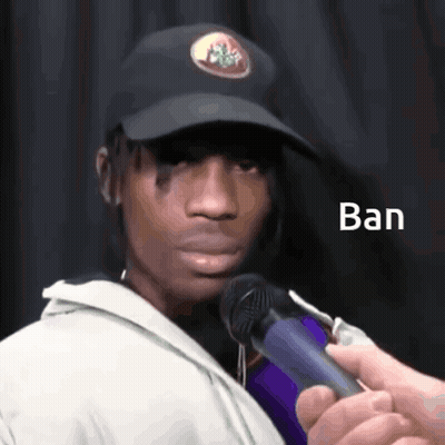 A Man Wearing A Black Hat Is Being Interviewed By Someone Holding A Microphone With The Word Ban Written On It GIF