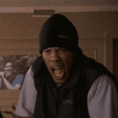 A Man Wearing A Black Hat Is Making A Funny Face . GIF