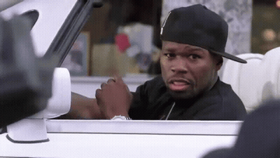 A Man Wearing A Black Hat Is Sitting In A White Car . GIF