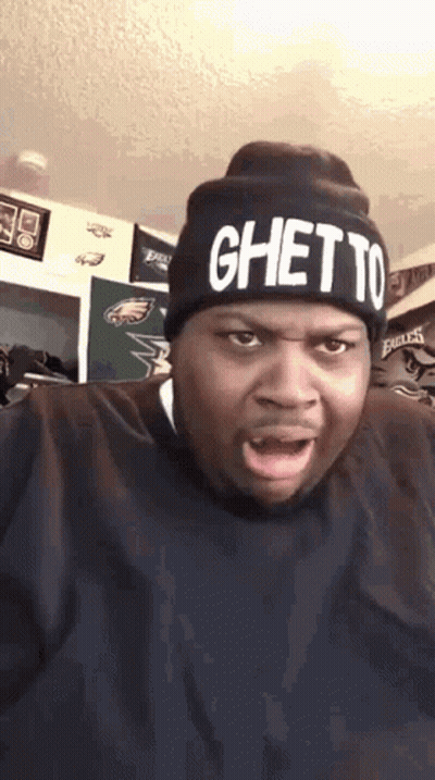 A Man Wearing A Black Hat That Says Ghetto On It GIF