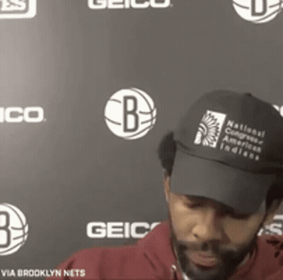A Man Wearing A Black Hat That Says National Congress Of American Indians On It GIF