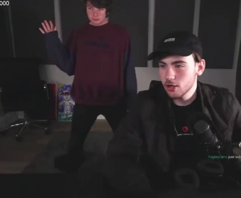 A Man Wearing A Black Hat That Says ' X-Men ' On It GIF