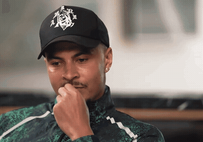A Man Wearing A Black Hat With A Picture Of A Man On It GIF