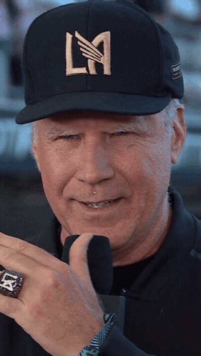 A Man Wearing A Black Hat With La Written On It GIF