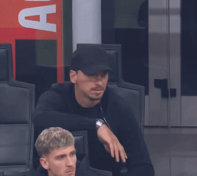 A Man Wearing A Black Hat With The Letter A On The Back GIF