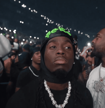A Man Wearing A Black Hat With The Word Sex Written On It GIF