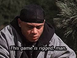A Man Wearing A Black Headband And A Gray Jacket Is Saying This Game Is Rigged , Man . GIF