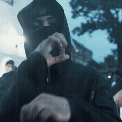 A Man Wearing A Black Hooded Jacket And A Ny Hat GIF
