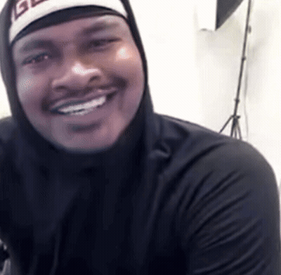 A Man Wearing A Black Hoodie And A Hat With The Letter G On It GIF