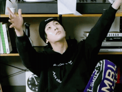 A Man Wearing A Black Hoodie That Says " Art Chic " On It GIF