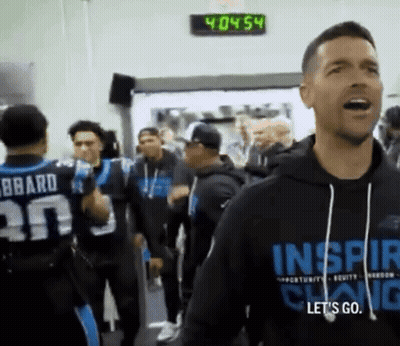 A Man Wearing A Black Hoodie That Says Inspire GIF