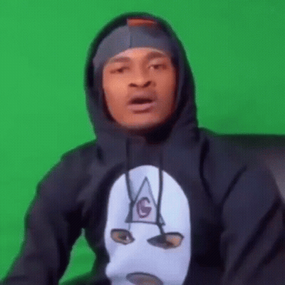 A Man Wearing A Black Hoodie With A Mask On His Face . GIF