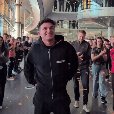 A Man Wearing A Black Hoodie With A White Label That Says ' X-Men ' On It GIF